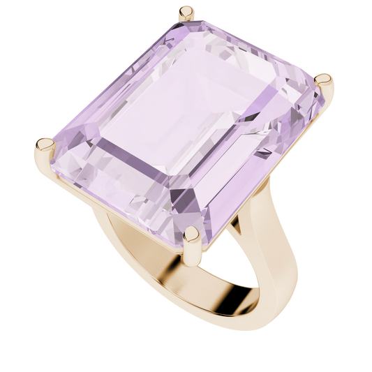 An emerald-cut rose gold ring with a large centerpiece gemstone, set on a sculpted band.